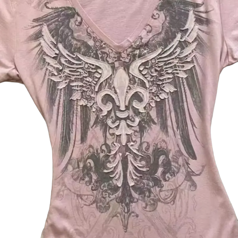 Seraphine graphic detail - winged fleur-de-lis and baroque scrollwork closeup